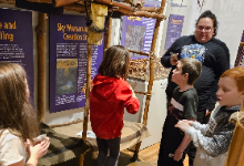 students in model of longhouse