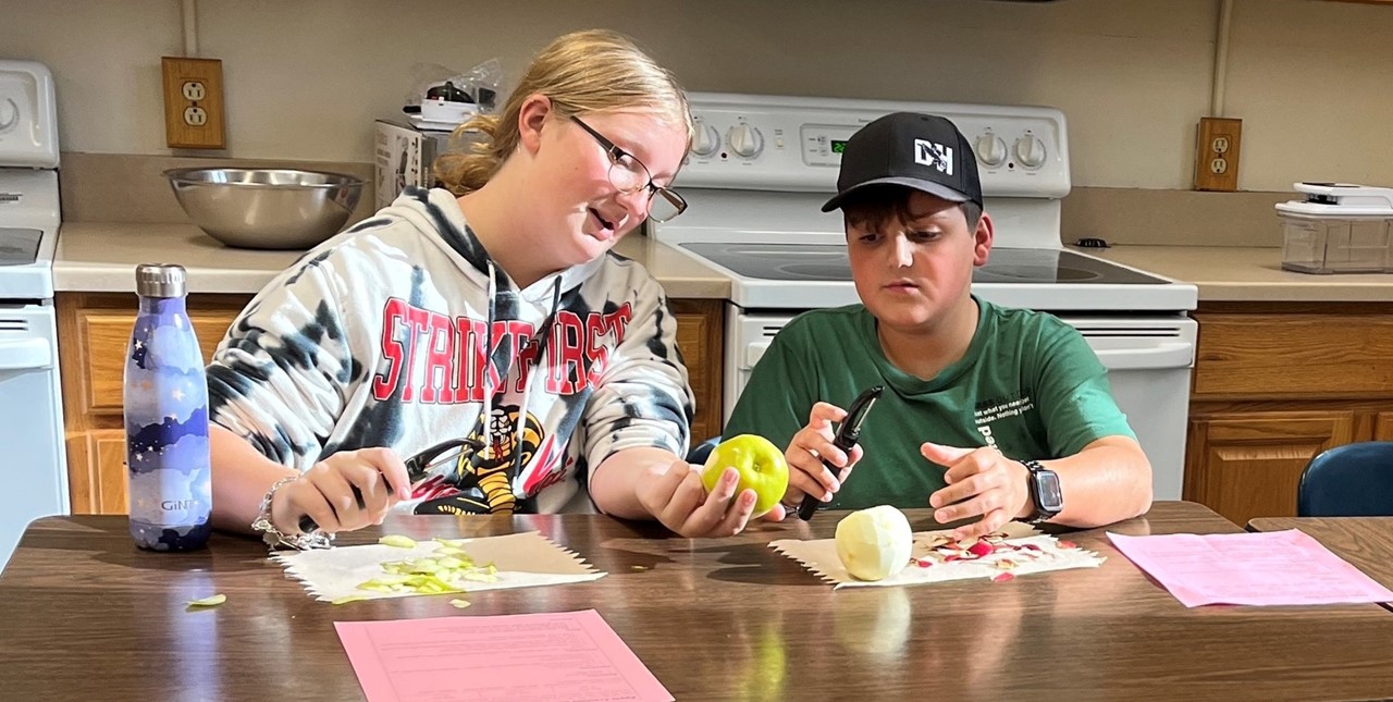two students peel apples