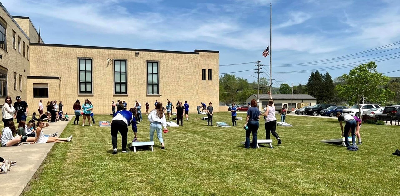 Group plays cornhole outside