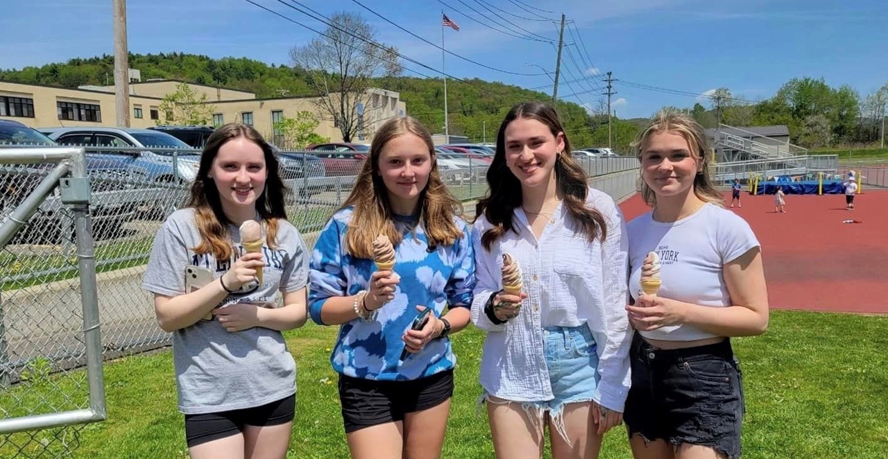 Four students with ice cream cones