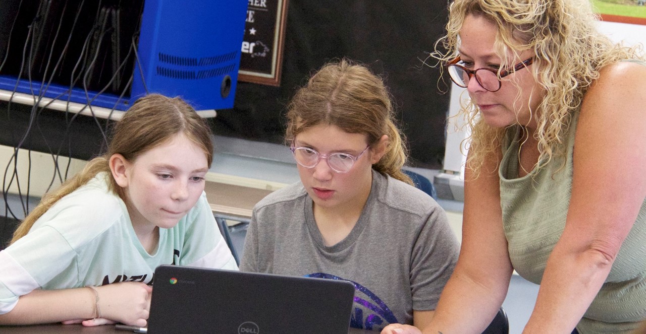 teacher and students at computer
