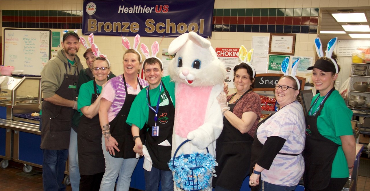 Food service staff pose with the Easter Bunny