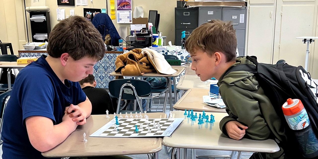 Two boys play chess